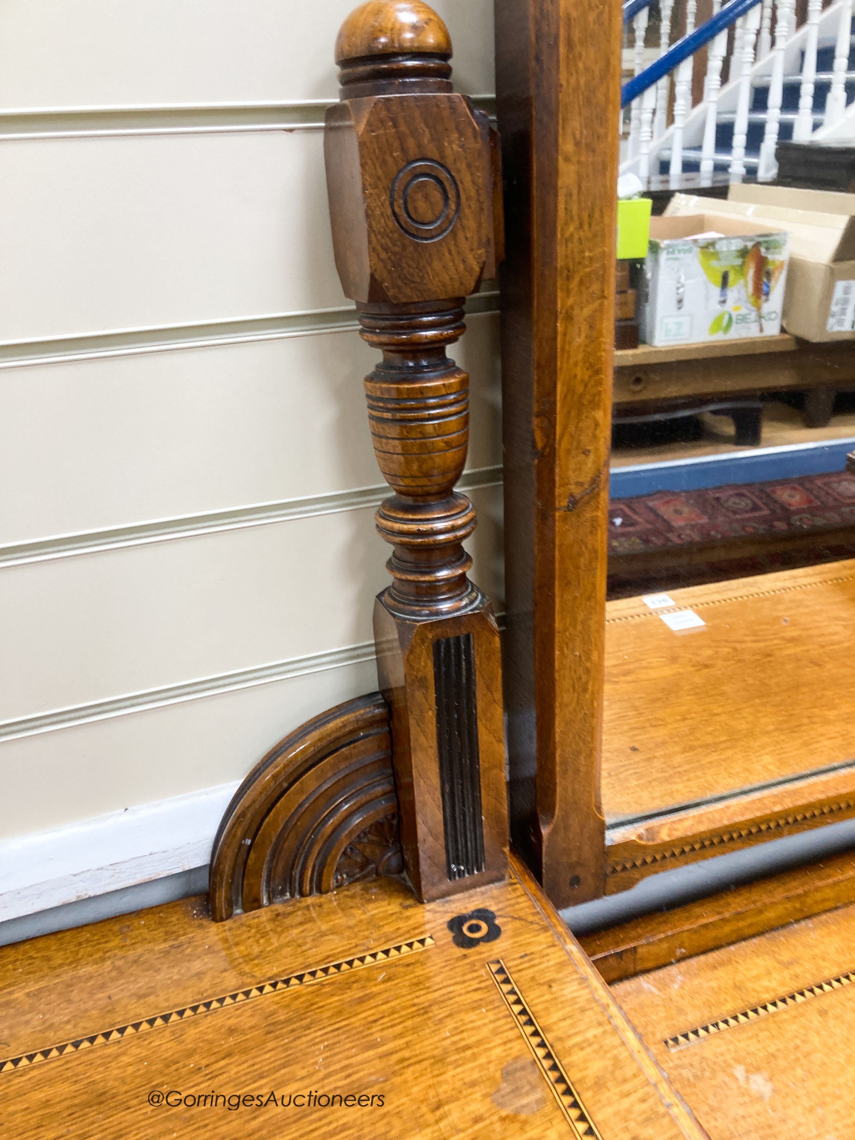 A late Victorian inlaid oak Aesthetic movement dressing table by Garnett & Son, Warrington, width 161cm, depth 59cm, height 176cm